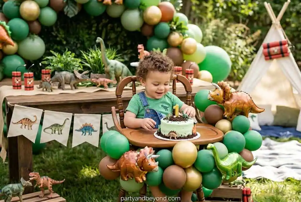 Dinosaur birthday party setup with excavation dig sand table and themed balloons