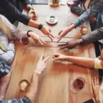 180+ Funny Ice Breaker Questions For Adults Group of adults playing ice breaker game at a social gathering.