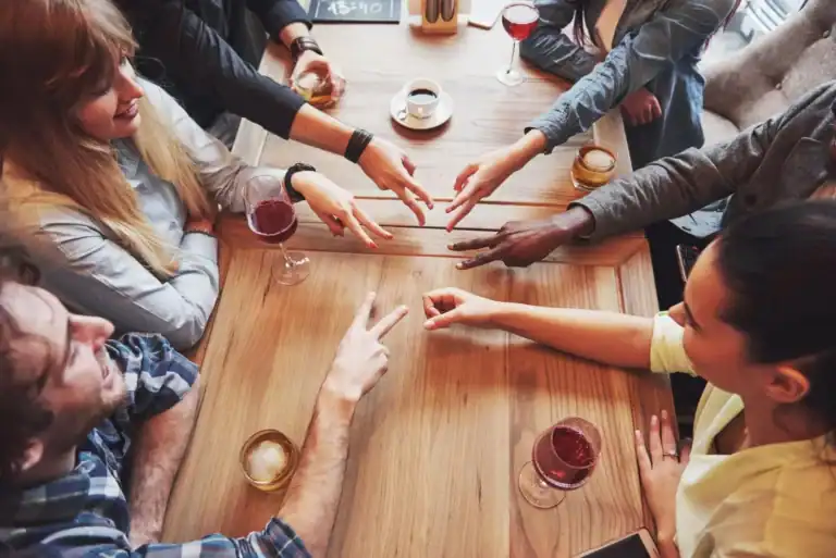 Group of adults playing ice breaker game at a social gathering.