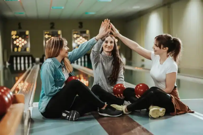 Group of women enjoying a fun girls' night at the bowling alley.