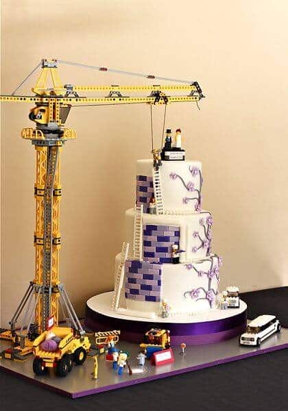 Building-brick construction toy lifting a wedding cake