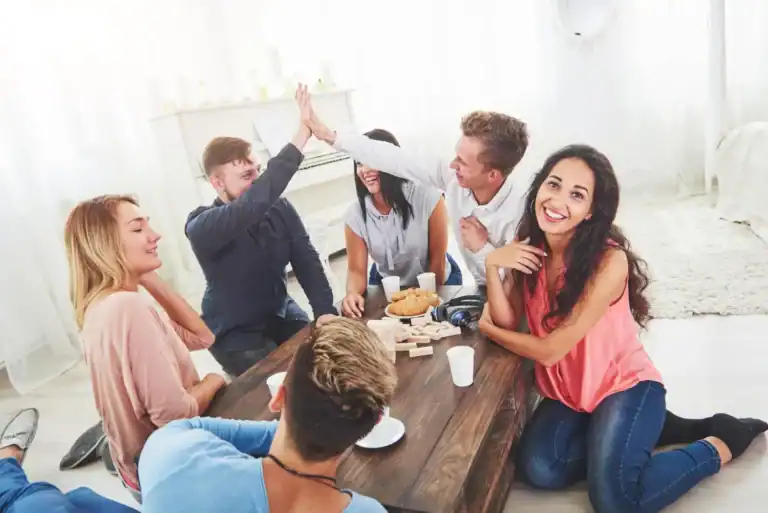 Group of teens enjoying fun icebreaker games at a party.