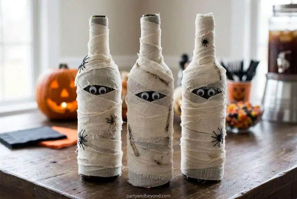 Halloween mummy wine bottle covers with gauze wrapping and googly eyes