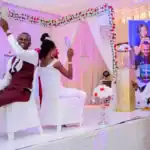 170+ Funny Wedding Shoe Game Questions Wedding shoe game with happy bride and groom on stage.