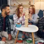 24 Latest Minute to Win It Games to Try in 2024 Fun Minute to Win It game with friends in a cozy living room.