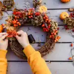 21 Rustic DIY Fall Decor Ideas for a Cozy Home Beautiful fall wreath with pumpkins, berries, and dried leaves for cozy home decor.