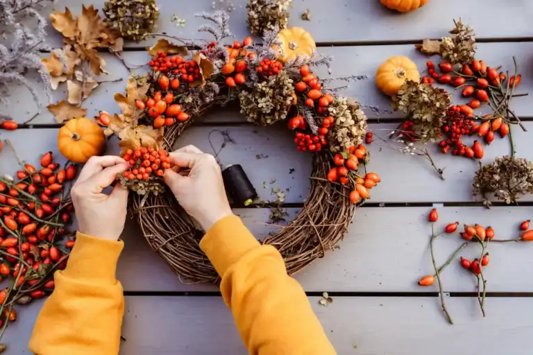 Beautiful fall wreath with pumpkins, berries, and dried leaves for cozy home decor.