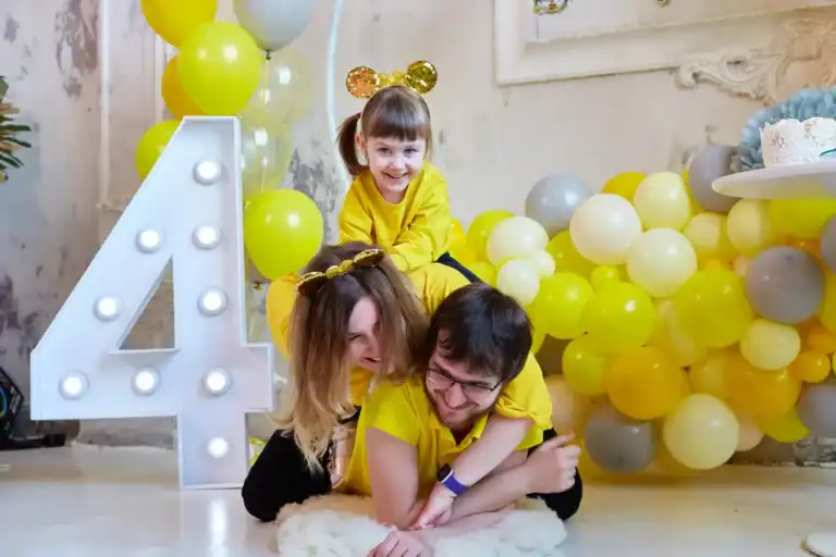 Bright birthday party with kids playing on the floor.