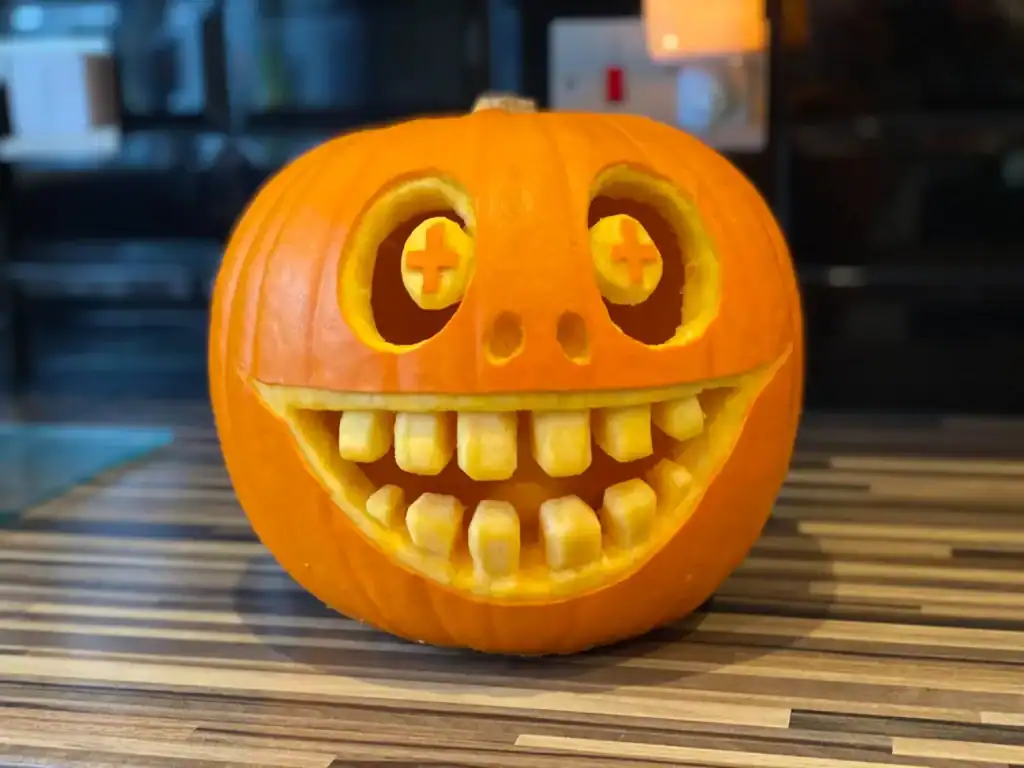 Pumpkin with a wide, smiling face and quirky eyes, perfect for festive Halloween decorations.