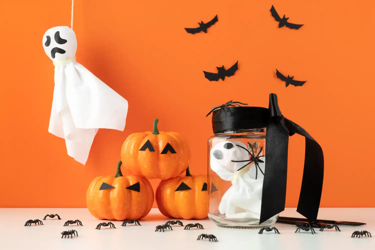 Festive Halloween indoor decorations featuring pumpkins, ghost figures, and spooky accents for a thr.