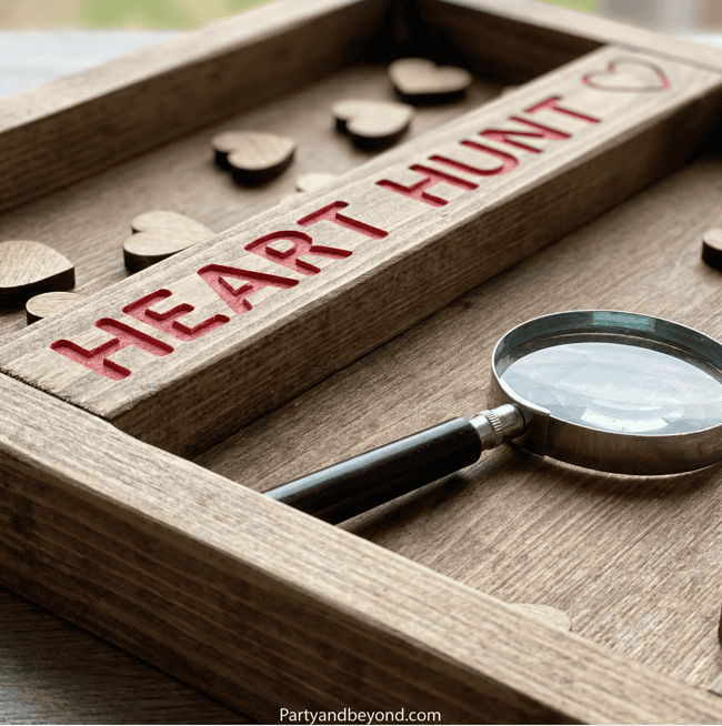 Wooden heart puzzle with magnifying glass for Valentine game.