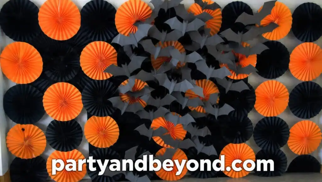 Halloween tissue pom-pom wall in black, plum, and orange for party photos