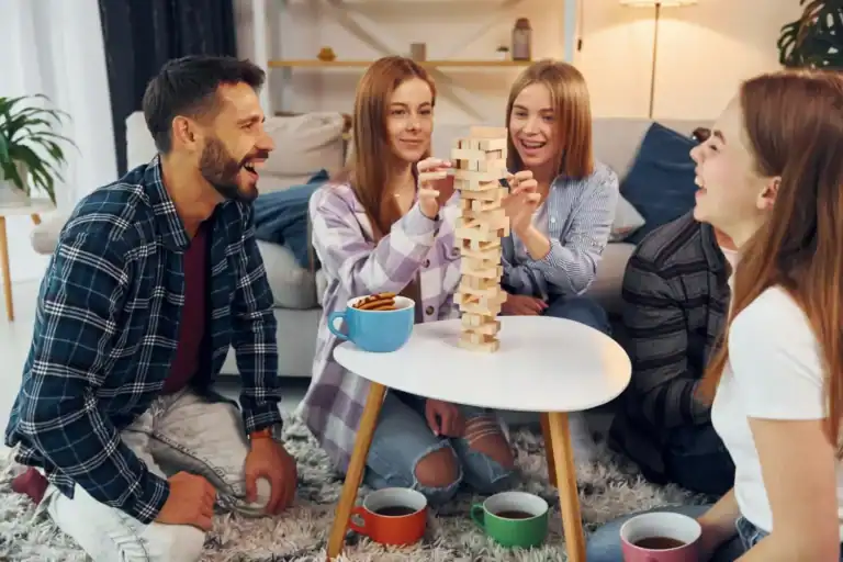 Fun Minute to Win It game with friends in a cozy living room.