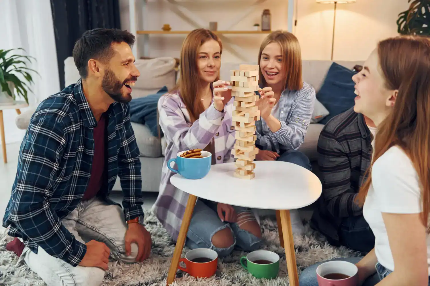 Fun Minute to Win It game with friends in a cozy living room.
