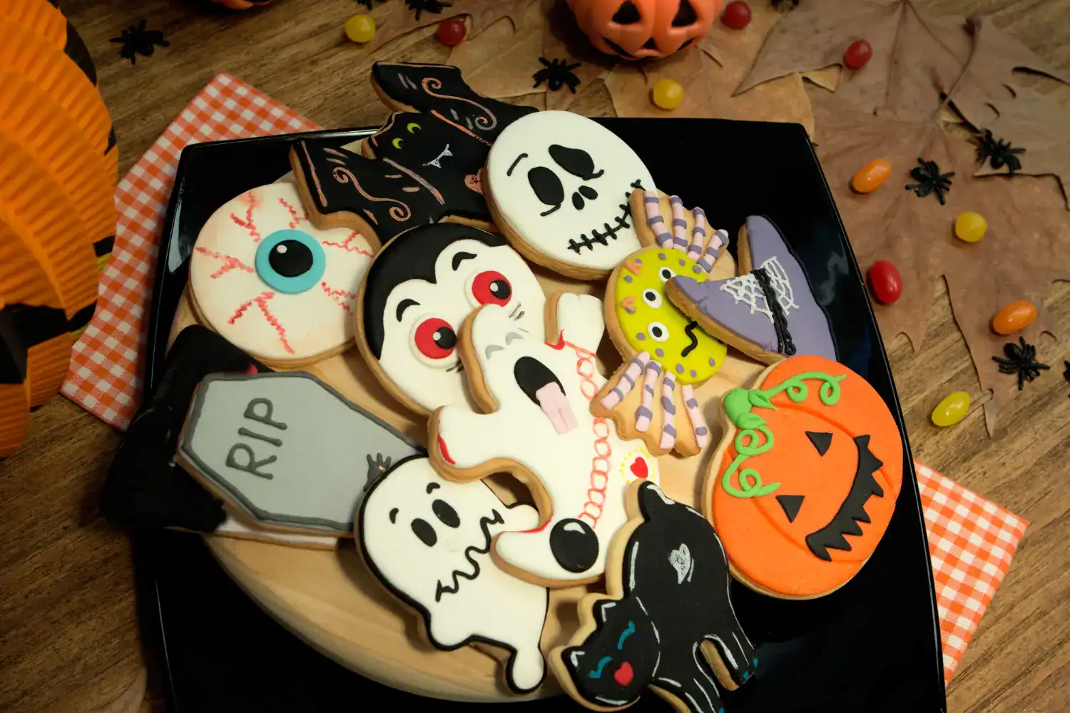 Halloween cookie decorations with ghosts, pumpkins, bats, and skulls for festive treats.