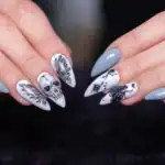 33 Spooky Horror Halloween Nail Designs 2026 – Ideas & Inspiration Halloween skull nail design with spooky black and white details for horror-themed nails.