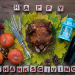 17 Thanksgiving Party Games to Make Your Holiday Unforgettable Festive Thanksgiving table with roasted turkey, pumpkins, and autumn decorations for holiday feast.