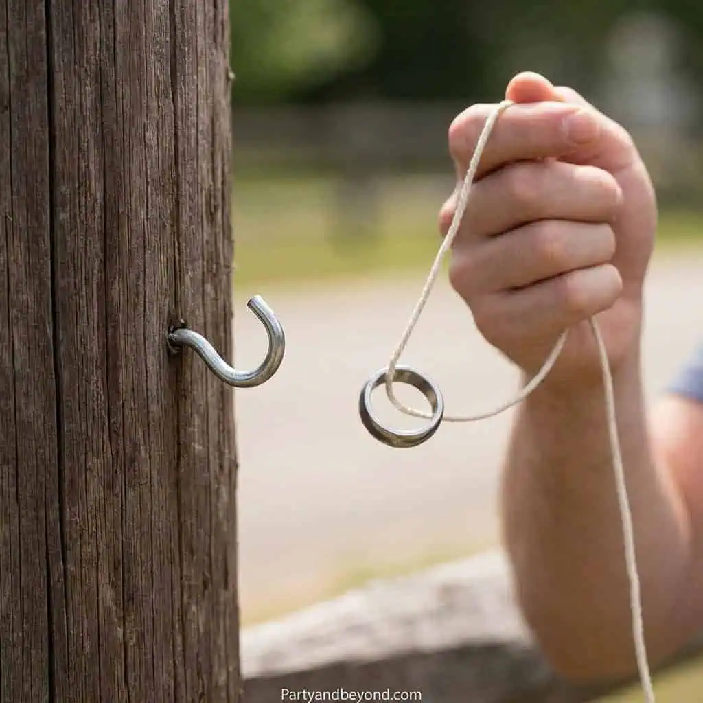 Hook and ring game at outdoor summer BBQ.