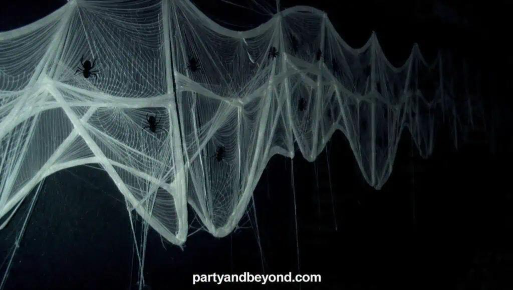 Giant spider web Halloween backdrop made from white yarn and decorative spiders