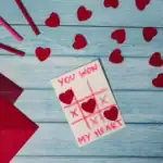 25 Fun & Easy Minute ‑ to ‑ Win ‑ It Valentine Games (2026 Edition) Winner of Valentine’s Day tic-tac-toe game with hearts and game card.