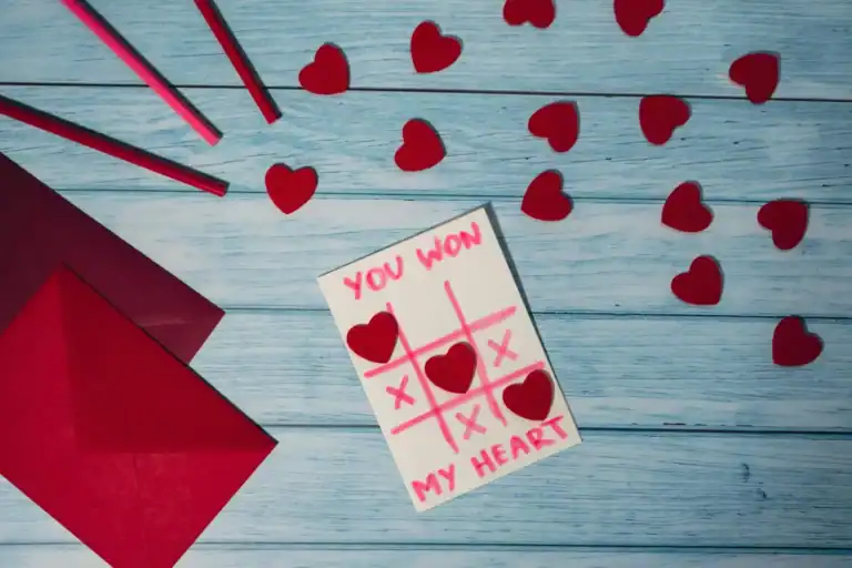 Winner of Valentine’s Day tic-tac-toe game with hearts and game card.