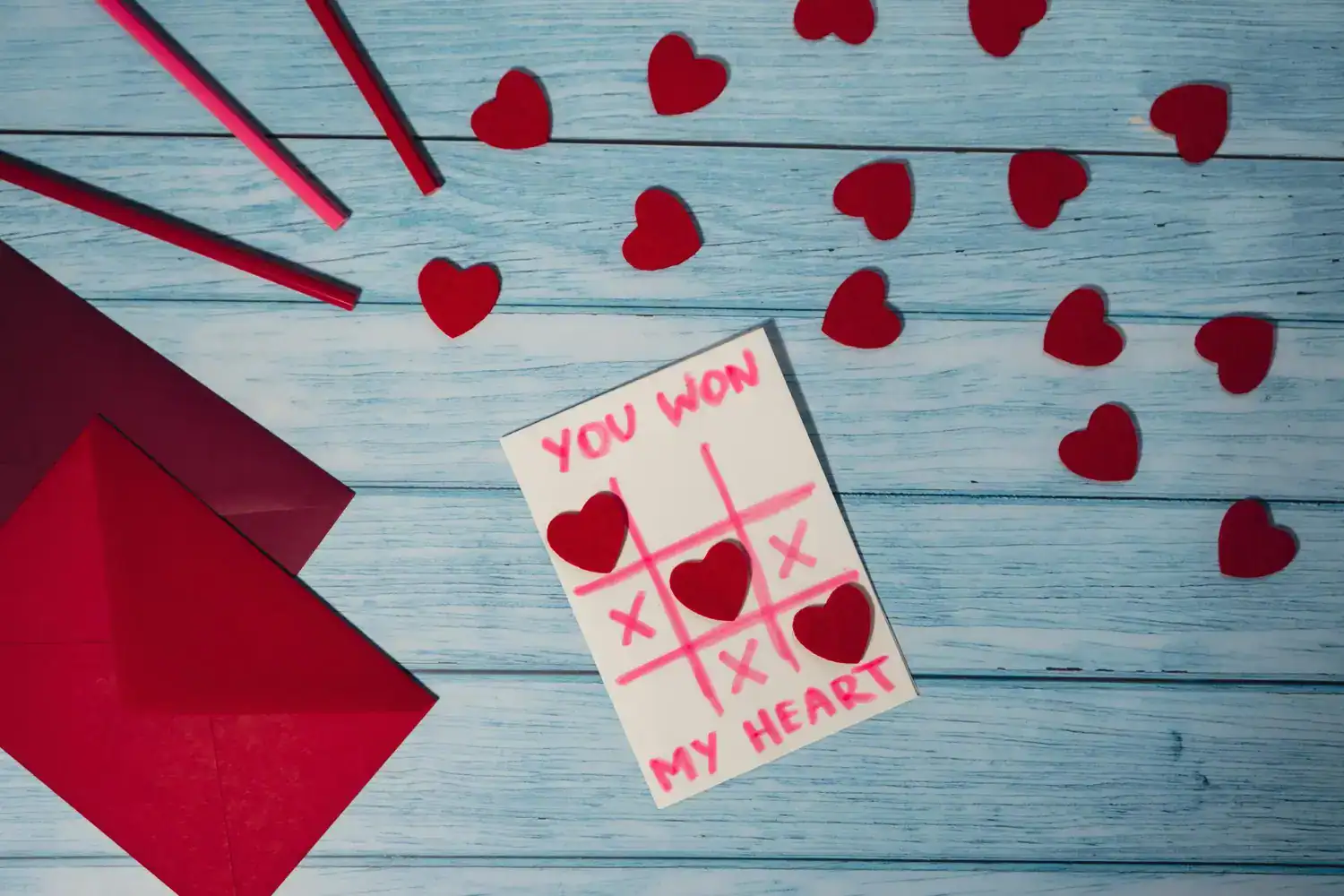 Winner of Valentine’s Day tic-tac-toe game with hearts and game card.