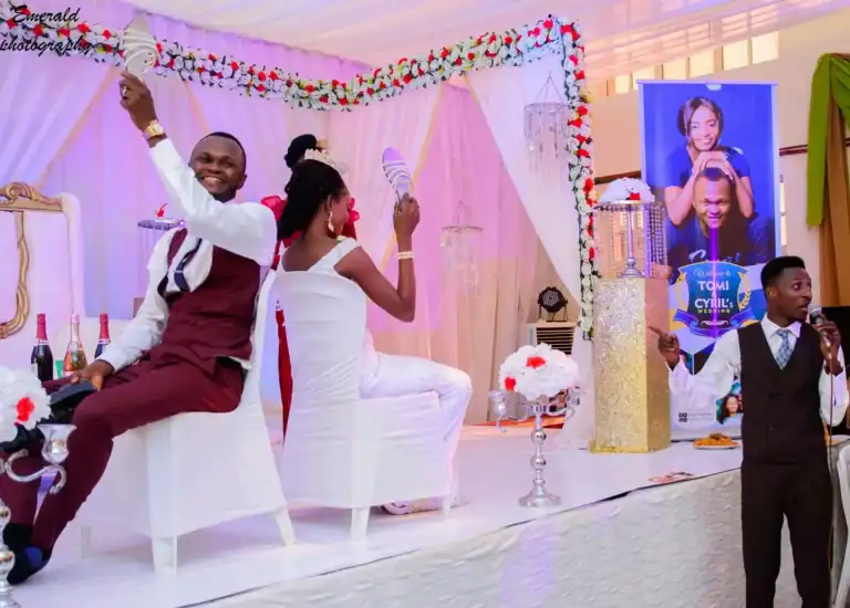 Wedding shoe game with happy bride and groom on stage.
