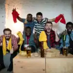 23 Bachelor Party Games to Make the Groom's Night Unforgettable Group of friends celebrating a bachelor party with drinks and fun.