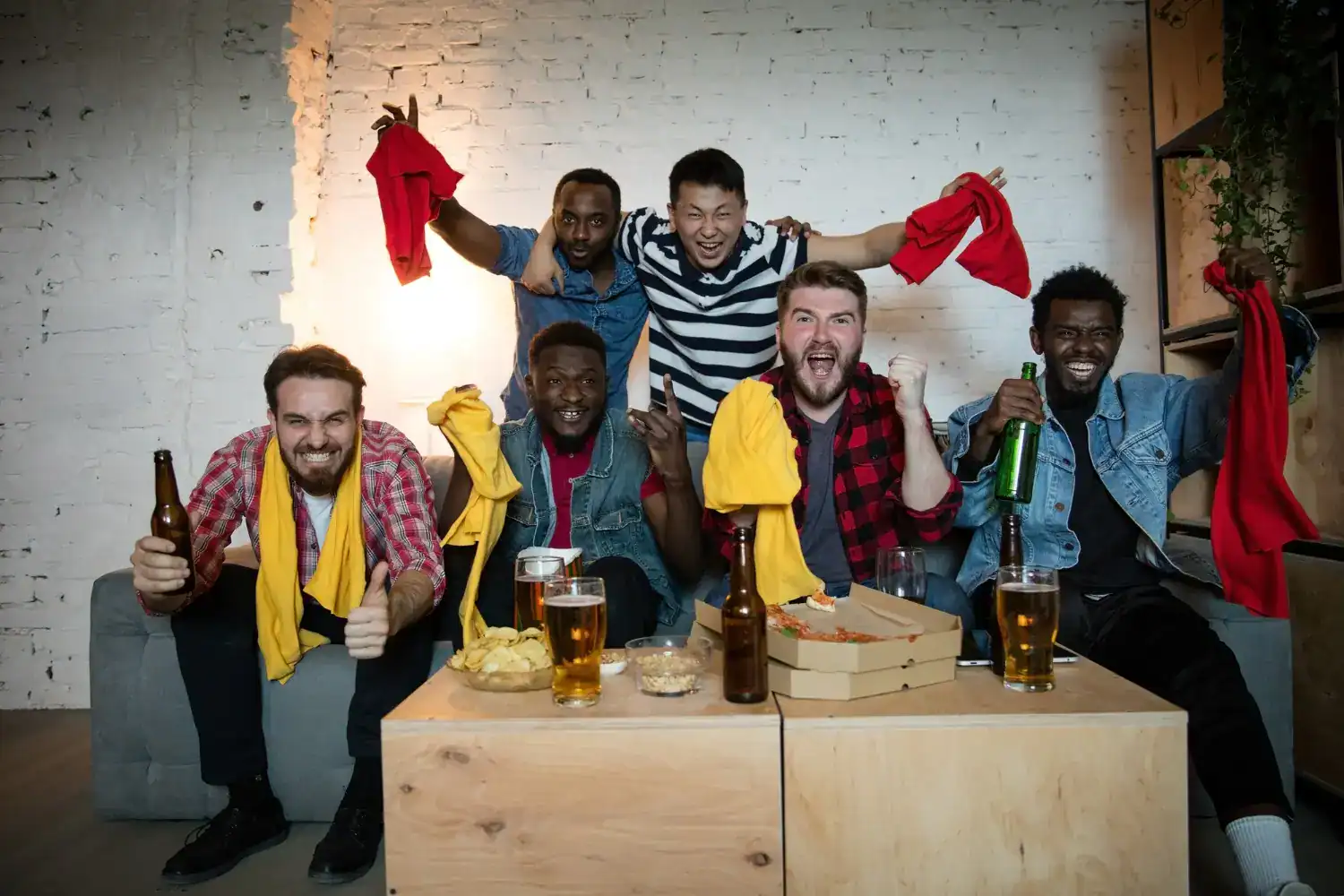 Group of friends celebrating a bachelor party with drinks and fun.
