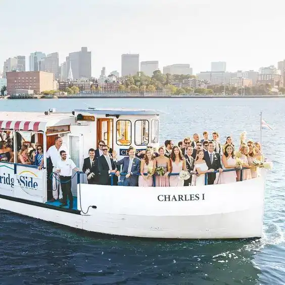 Boat wedding reception with bridal party and guests on a river cruise.