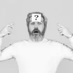 61 "Who Knows Me Best" Questions for Birthday Parties 2026 Man with a question mark on his forehead, pointing to his head, celebrating birthday fun.