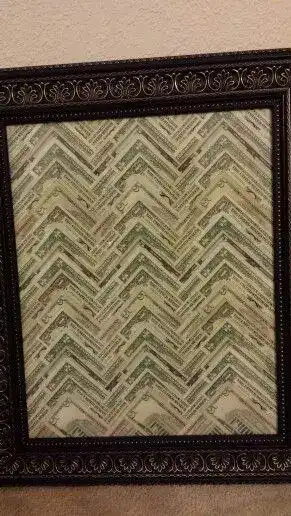 Elegant chevron patterned mirror with ornate black frame.