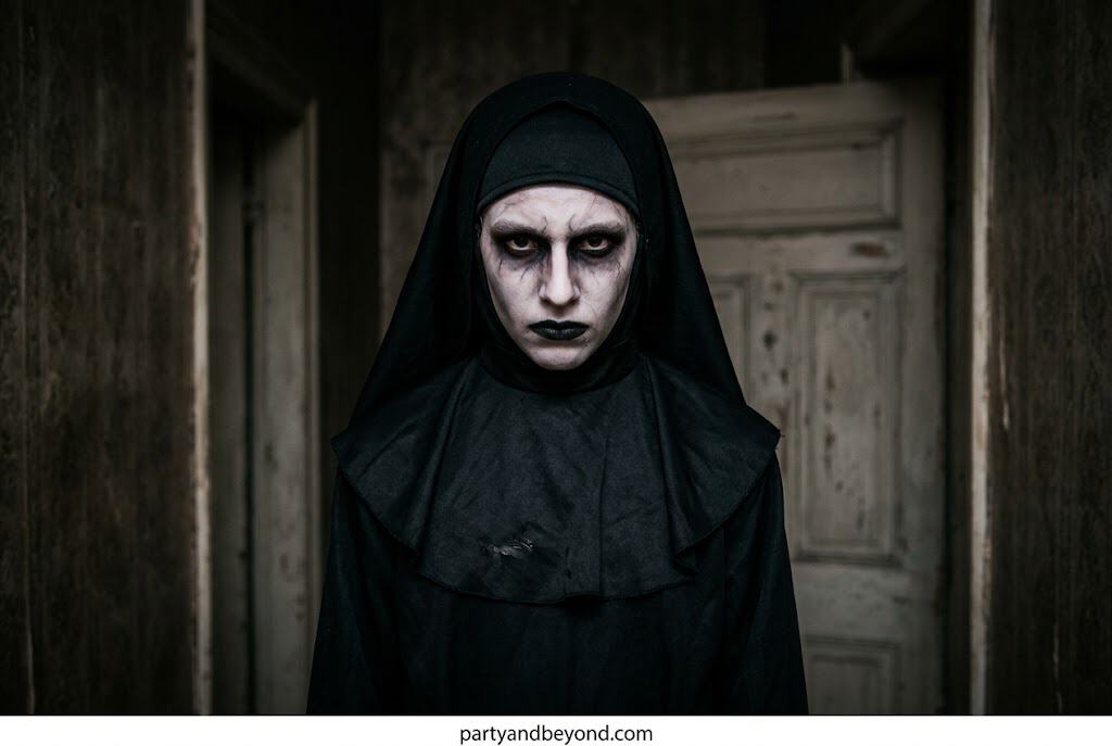 Scary Valak Nun Halloween costume with white makeup and black robe