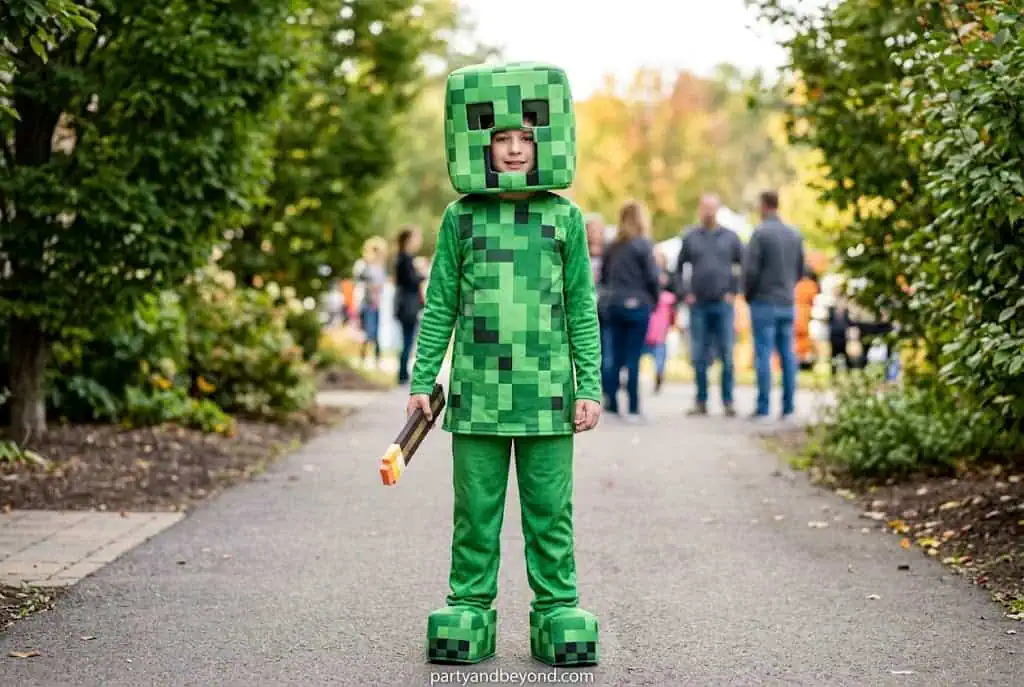 Teen boy wearing green Minecraft Creeper costume for Halloween