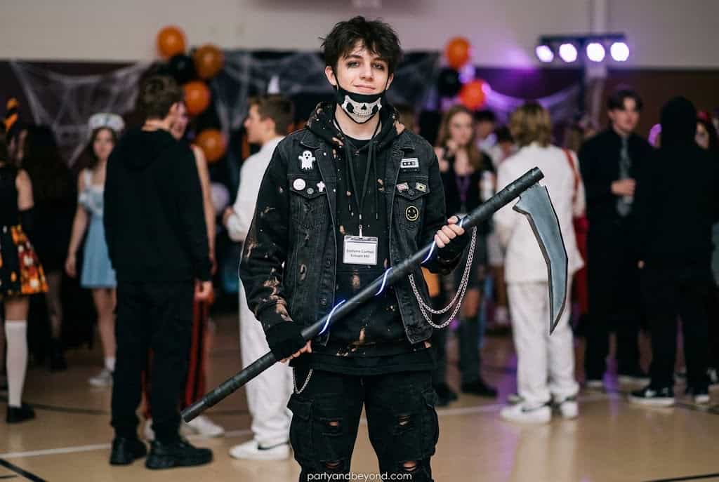 Modern Grim Reaper Halloween costume holding smartphone instead of scythe