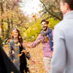 23 Fun Thanksgiving Games for Adults to Celebrate Together Celebrating Thanksgiving with friends outdoors in fall foliage.