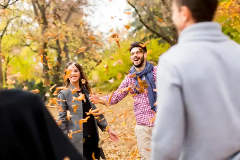 Celebrating Thanksgiving with friends outdoors in fall foliage.
