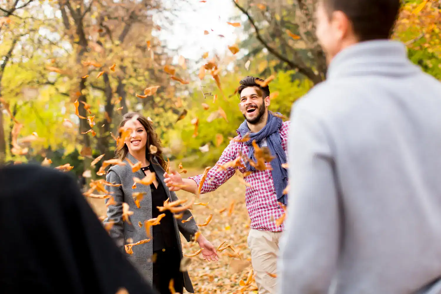 Celebrating Thanksgiving with friends outdoors in fall foliage.