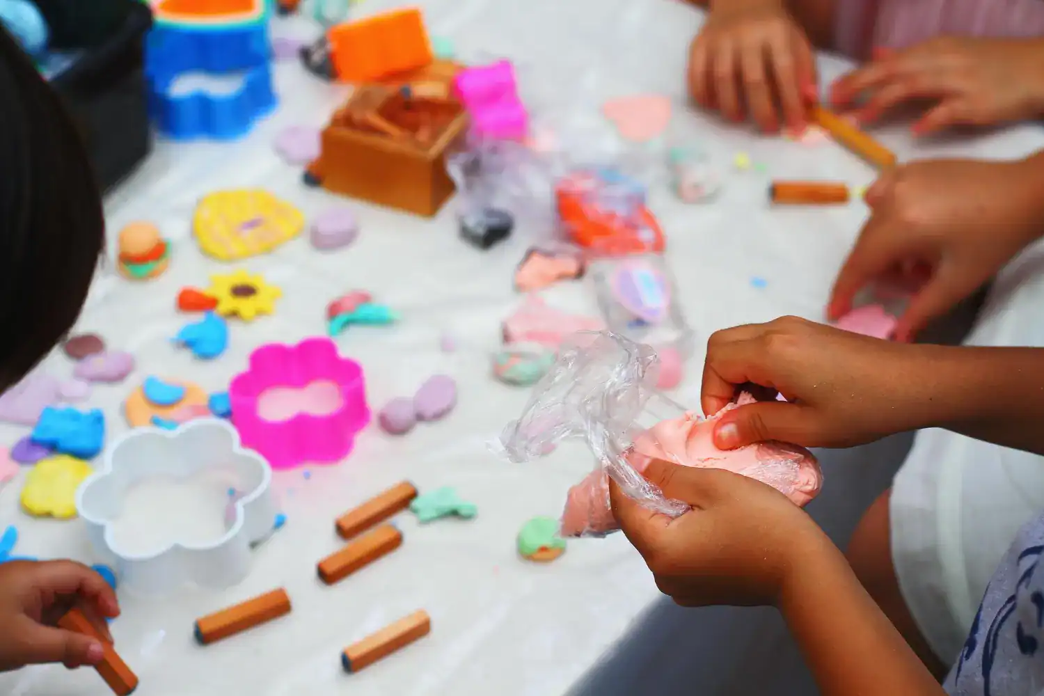 Children engaging in sensory play with clay and textured materials for sensory development.