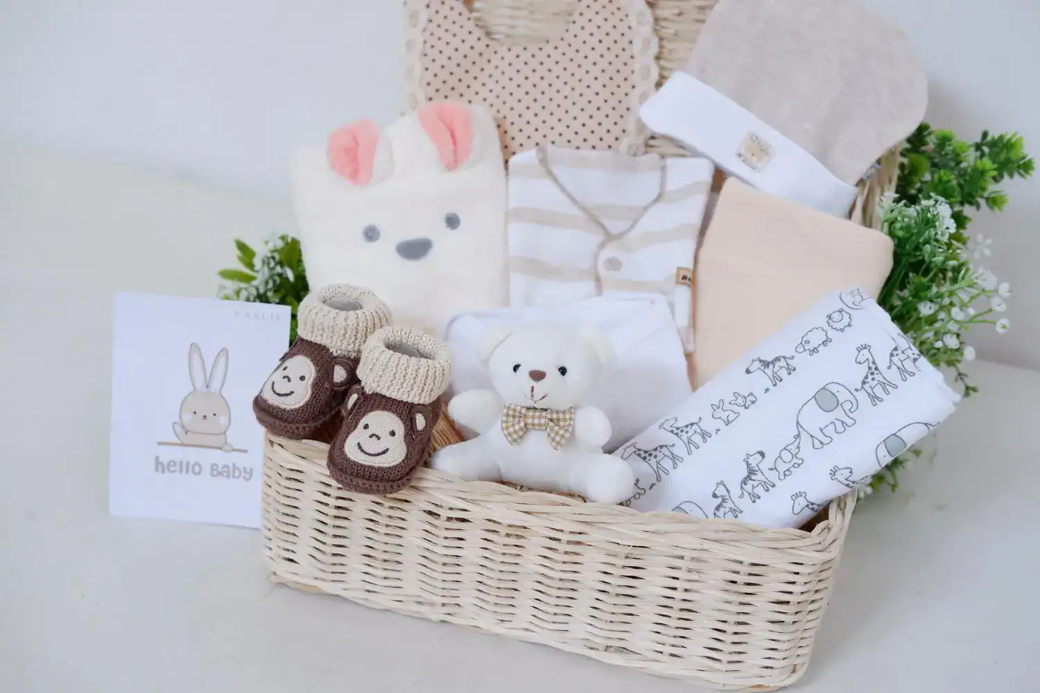 Adorable baby shower gift basket featuring plush toys, cozy socks, and baby clothing for new moms an.