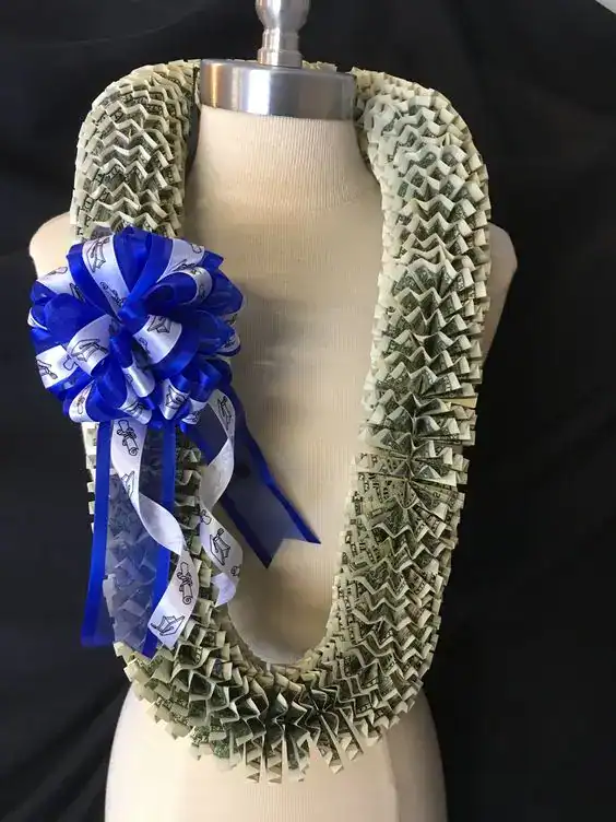 DIY money lei made with folded dollar bills and ribbon, a popular graduation gift for teens
