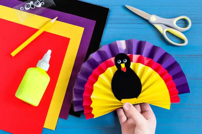 Colorful paper turkey craft for kids' Thanksgiving activities. Easy DIY craft with paper, glue, and.