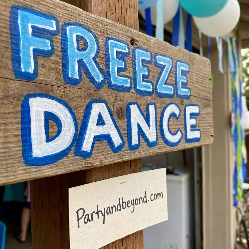 Colorful Freeze Dance sign for teen party games at a fun outdoor event.