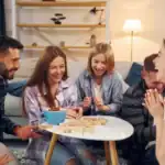 23 Fun Friendsgiving Games for Adults to Enjoy Together Group of friends enjoying fun Friendsgiving games indoors.