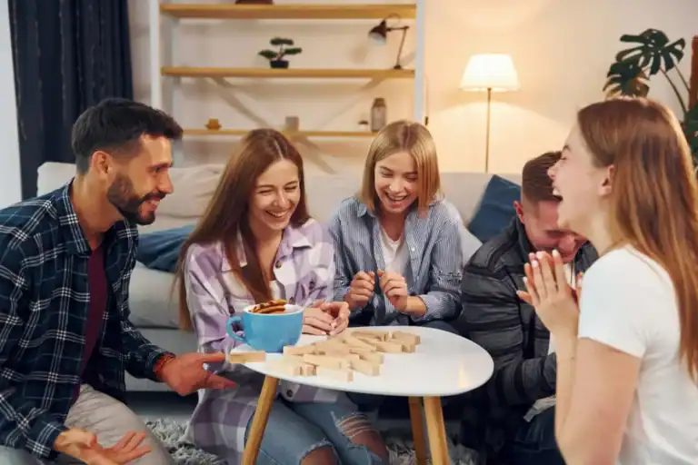 Group of friends enjoying fun Friendsgiving games indoors.