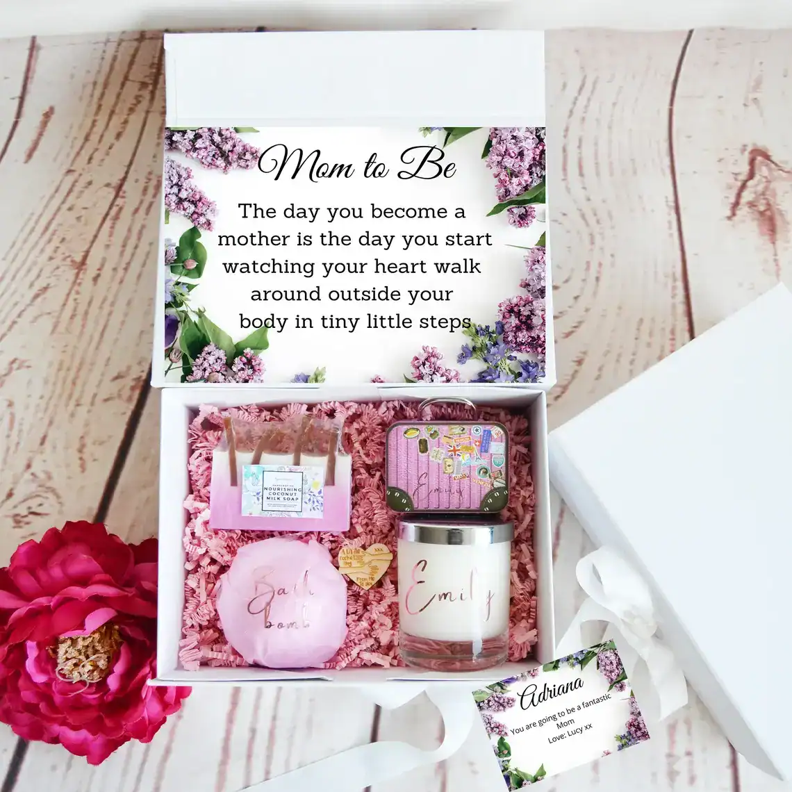 Baby shower gift set with personalized items and floral theme for new moms.