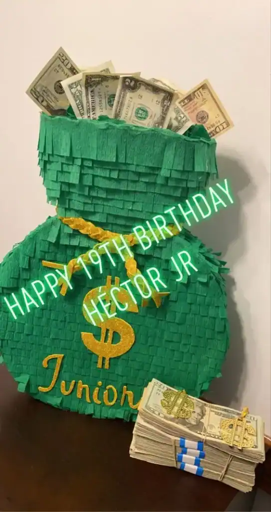 Green and gold piñata filled with dollar bills for a teen birthday party money gift