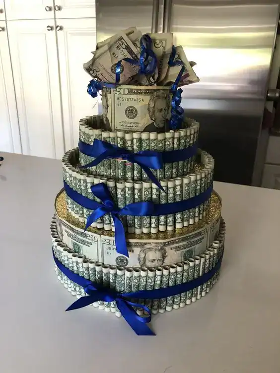 Money gift cake made of rolled dollar bills with blue ribbons, perfect for celebrating teens' specia.