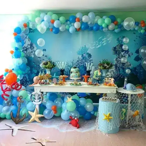 Underwater ocean-themed birthday party with balloons, sea creatures, and marine decorations. Perfect.