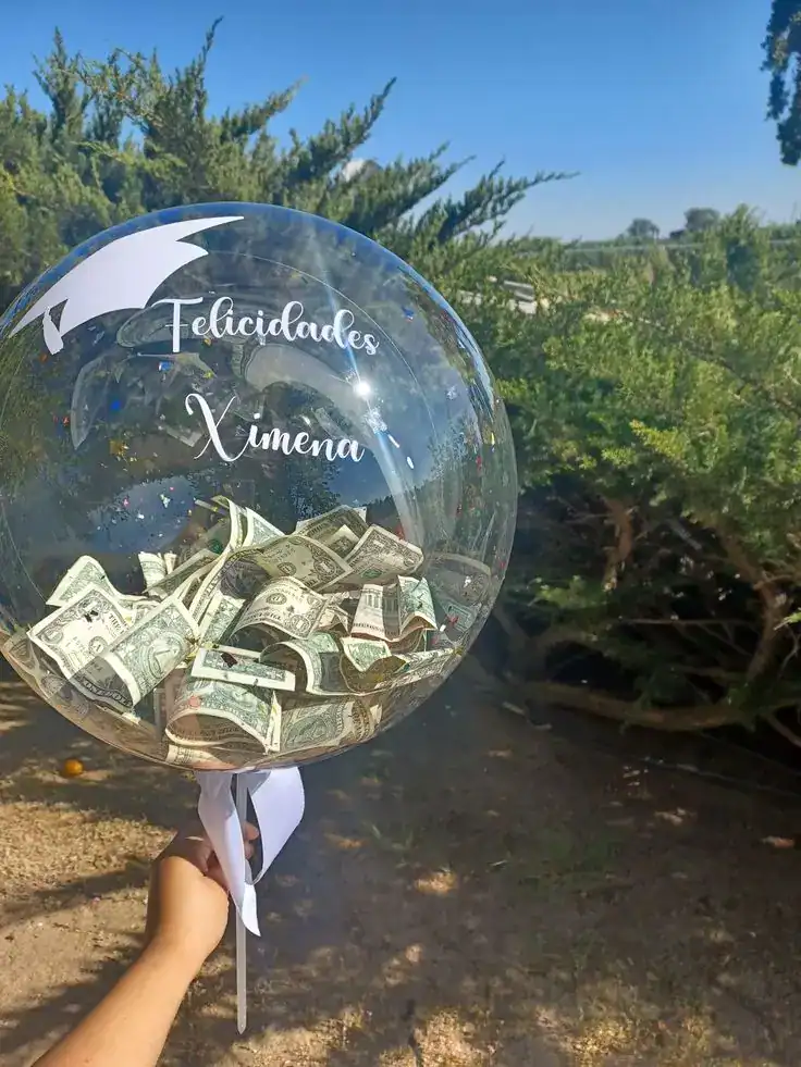 Money-filled balloons tied with ribbon as a surprise money gift for teens at a party